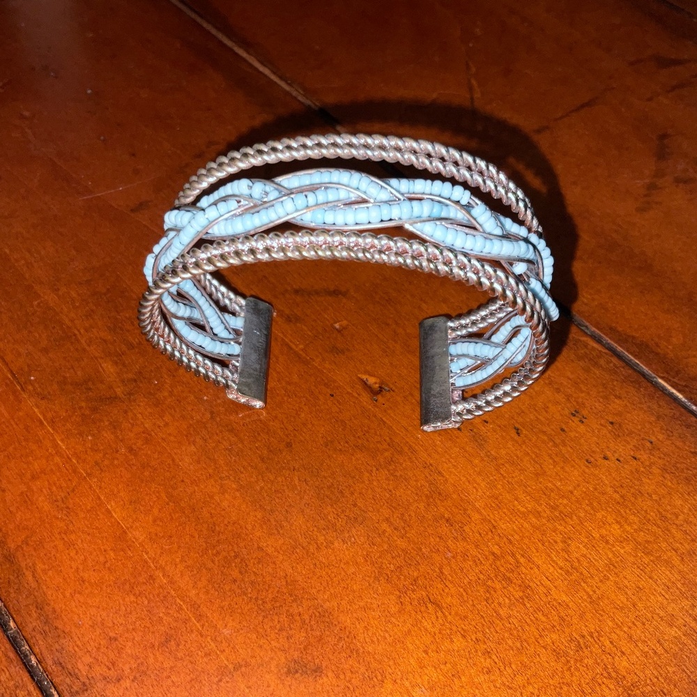 Silver plated bangle bracelet With blue beads.